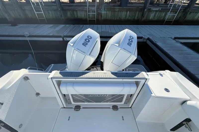 Slide: The Image of 2022 Blackfin 252 CC boat with twin Mercury outboard engines at dock. - 6
