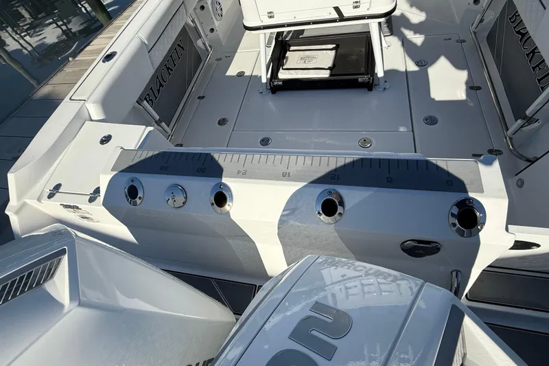 Slide: The Image of 2022 Blackfin 252 CC boat interior with fishing rod holders and seating. - 7