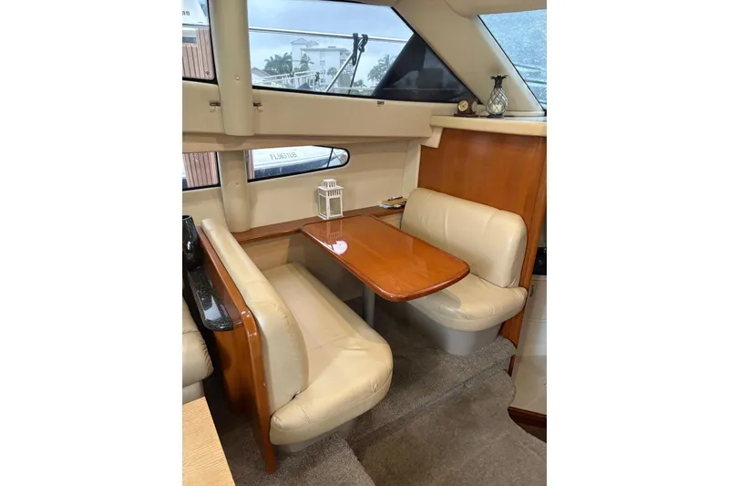 Slide: The Image of Interior of 2005 Carver 41 Cockpit Motor Yacht with cozy dining area. - 15