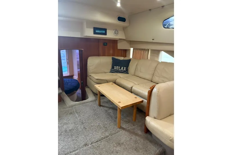 Slide: The Image of Luxurious interior of 2005 Carver 41 Cockpit Motor Yacht with beige seating and wooden table. - 18