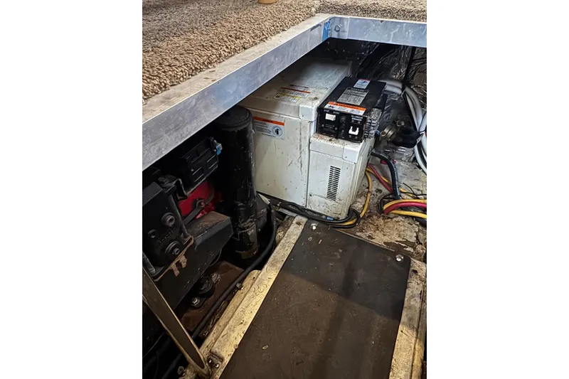 Slide: The Image of Engine compartment of 2005 Carver 41 Cockpit Motor Yacht, showing generator and wiring. - 19