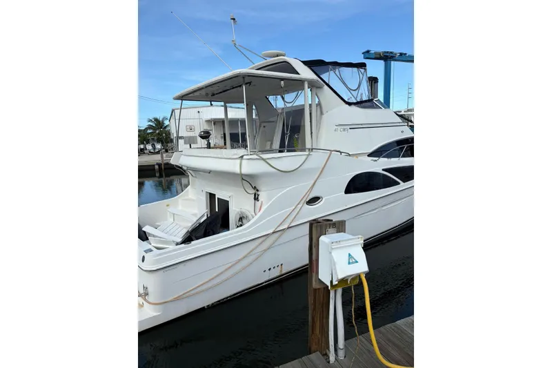 Slide: The Image of 2005 Carver 41 Cockpit Motor Yacht docked at marina, side view. - 4
