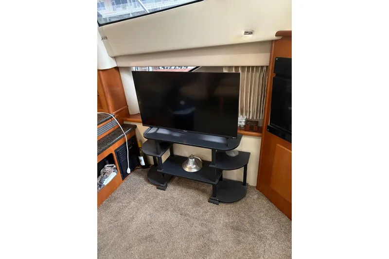 Slide: The Image of Flat-screen TV on stand inside 2005 Carver 41 Cockpit Motor Yacht cabin. - 13