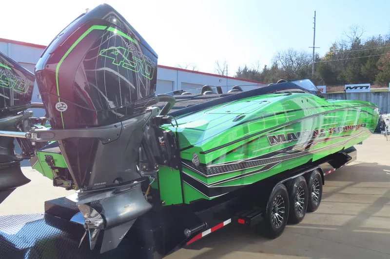 Slide: The Image of 2023 MTI 390X powerboat with vibrant green design and powerful outboard engines. - 15