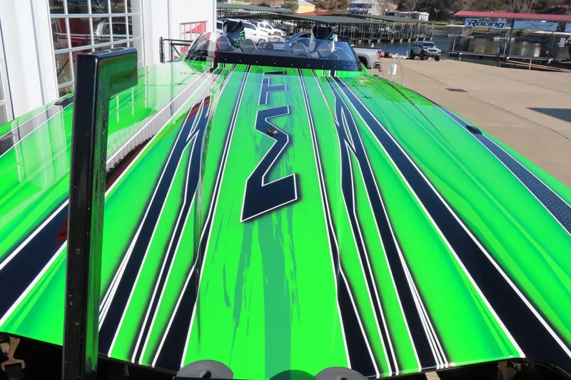 Slide: The Image of Bright green MTI 390X boat with sleek black and white stripes, 2023 model. - 18