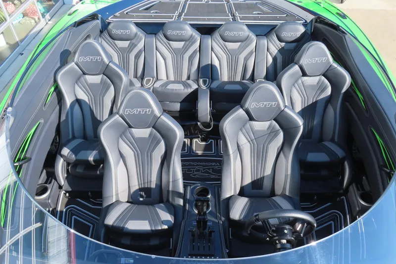 Slide: The Image of 2023 MTI 390X boat interior with sleek gray seats and modern design. - 20