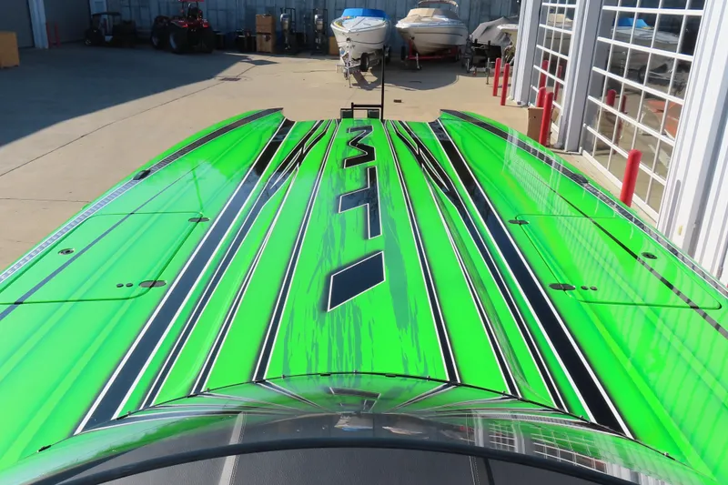 Slide: The Image of Bright green MTI 390X boat, 2023 model, with sleek black and white stripes. - 22
