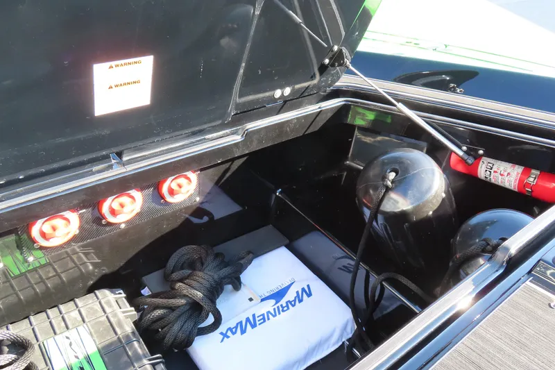 Slide: The Image of Open storage compartment of 2023 MTI 390X boat with safety equipment and accessories. - 24