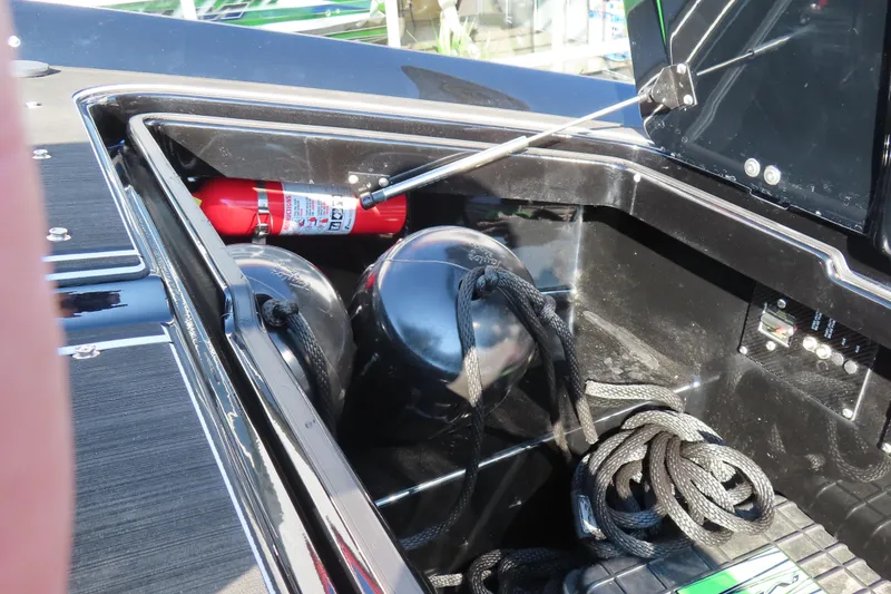 Slide: The Image of Storage compartment of 2023 MTI 390X boat with fire extinguisher and ropes. - 25