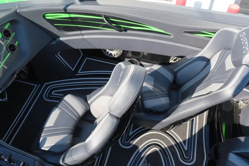 Slide: The Image of Interior of 2023 MTI 390X boat with sleek black and green design. - 29