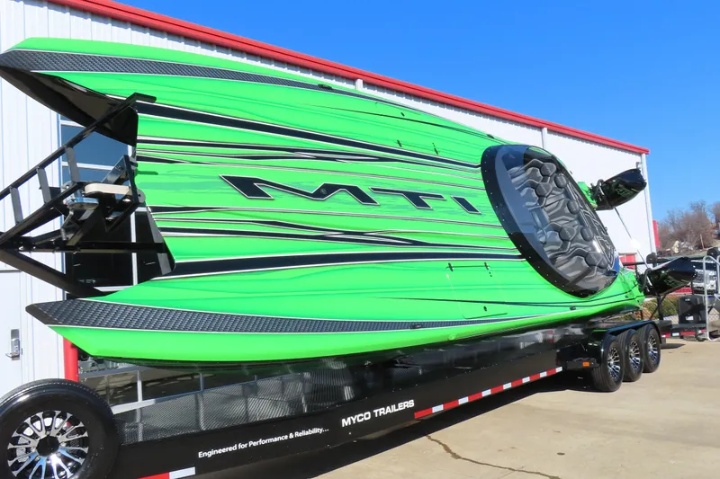 Slide: The Image of Bright green 2023 MTI 390X powerboat on trailer, showcasing sleek design and performance. - 3