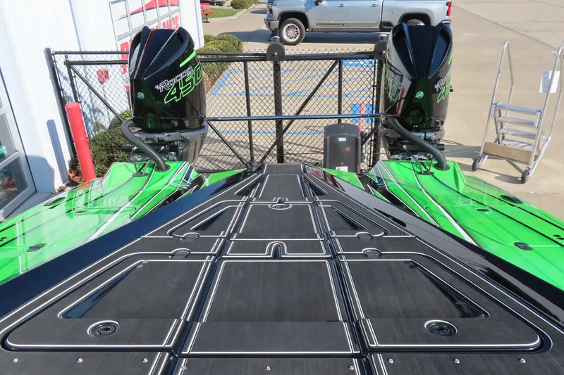 Slide: The Image of 2023 MTI 390X boat with twin 450R engines, vibrant green and black design. - 34