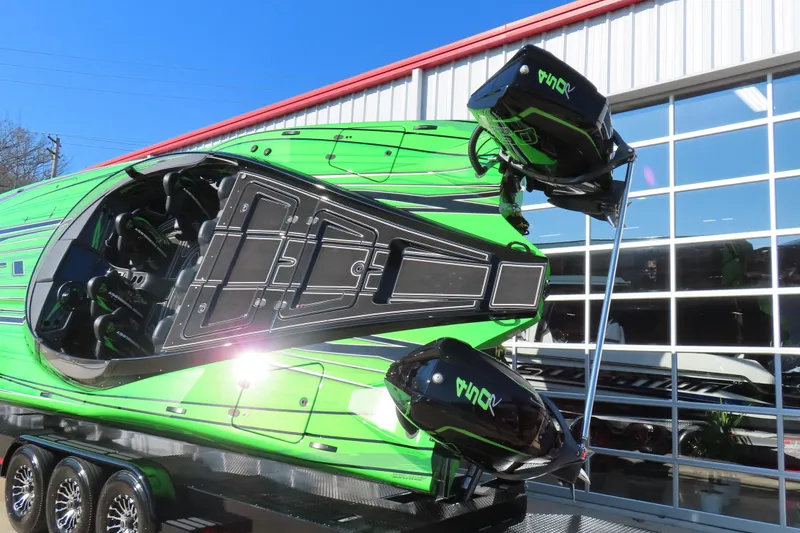 Slide: The Image of 2023 MTI 390X powerboat in vibrant green with dual engines on display. - 4