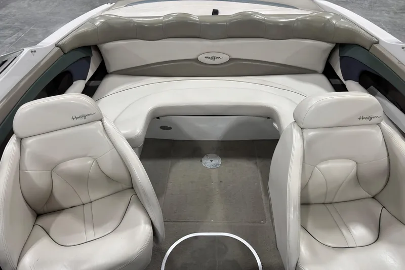 Slide: The Image of 1999 Four Winns 220 Horizon SS boat interior with white leather seating. - 12