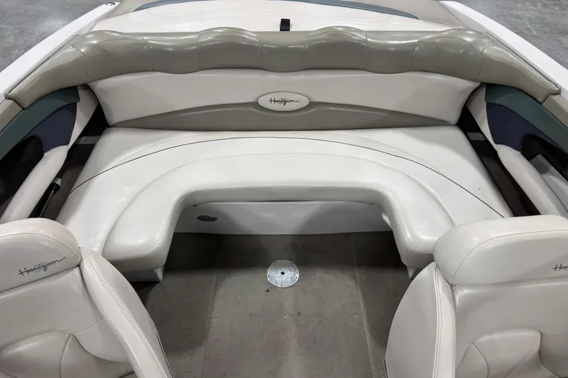 Slide: The Image of 1999 Four Winns 220 Horizon SS boat interior with white leather seating. - 13