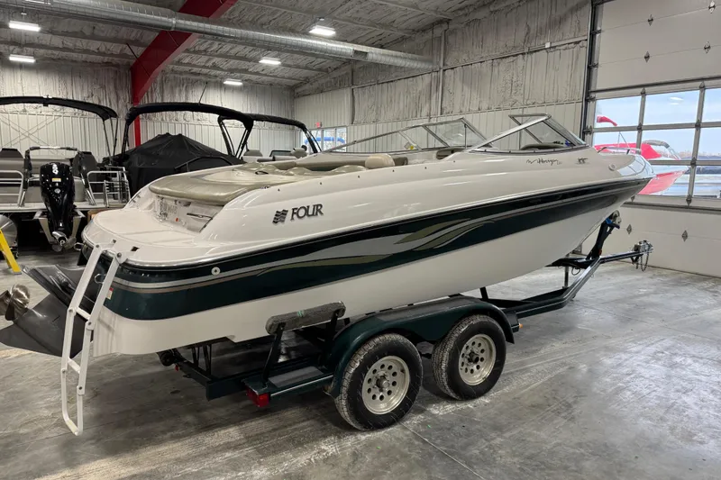 Slide: The Image of 1999 Four Winns 220 Horizon SS boat on trailer in indoor showroom. - 3