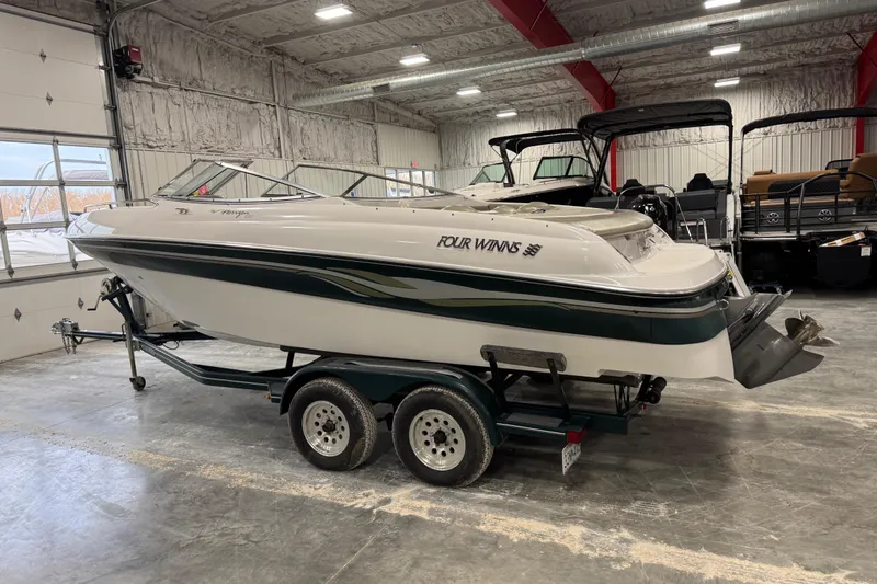 Slide: The Image of 1999 Four Winns 220 Horizon SS boat on trailer in indoor storage facility. - 4