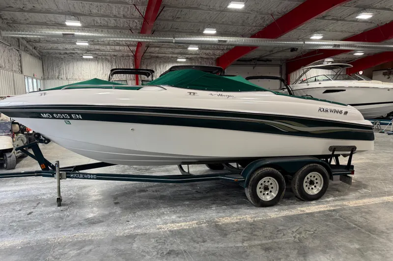 Slide: The Image of 1999 Four Winns 220 Horizon SS boat on trailer in indoor storage facility. - 5