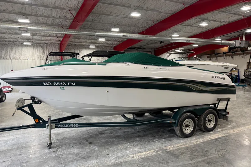 Slide: The Image of 1999 Four Winns 220 Horizon SS boat on trailer in indoor storage facility. - 7