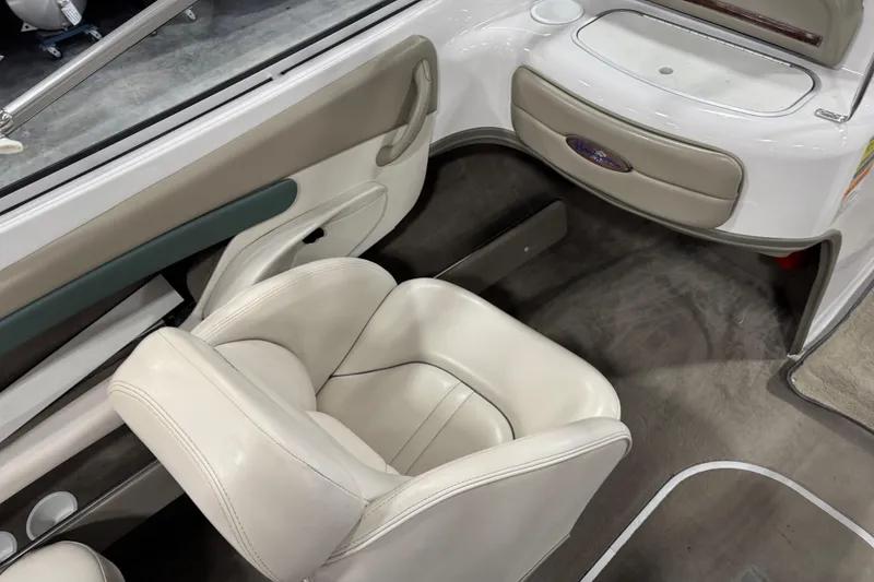 Slide: The Image of 1999 Four Winns 220 Horizon SS boat interior with white seating and dashboard. - 9