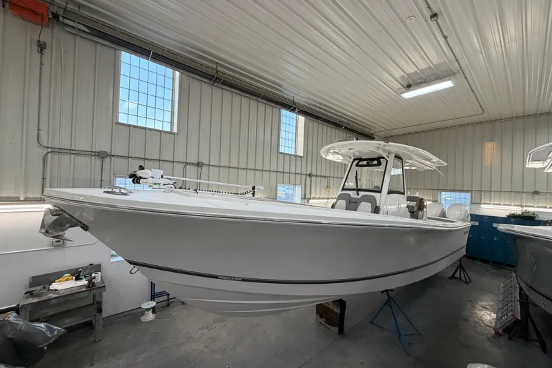 The Image of 2024 Regulator 34 boat in a well-lit indoor storage facility. - 0