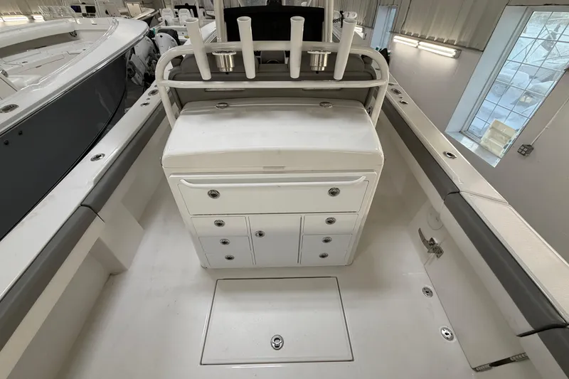 Slide: The Image of 2024 Regulator 34 boat interior with storage compartments and rod holders. - 16