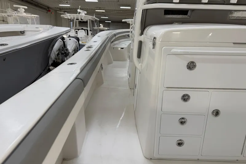 Slide: The Image of 2024 Regulator 34 boat interior with storage compartments and sleek design. - 19
