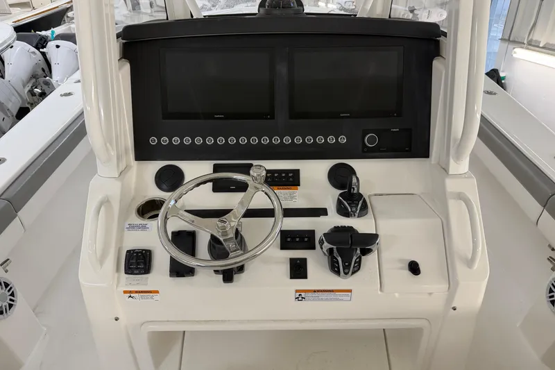 Slide: The Image of 2024 Regulator 34 boat dashboard with dual screens and modern controls. - 23