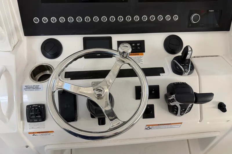Slide: The Image of 2024 Regulator 34 boat dashboard with steering wheel and controls. - 25