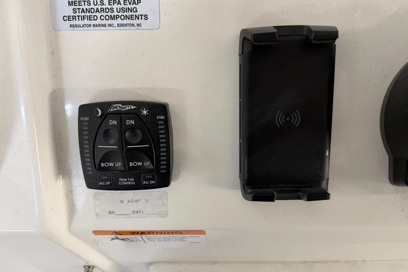 Slide: The Image of 2024 Regulator 34 boat control panel with Bennett trim tab and phone holder. - 26