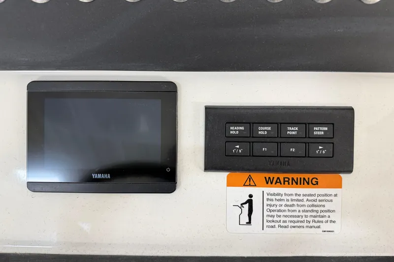 Slide: The Image of Control panel of 2024 Regulator 34 boat with Yamaha display and warning label. - 27