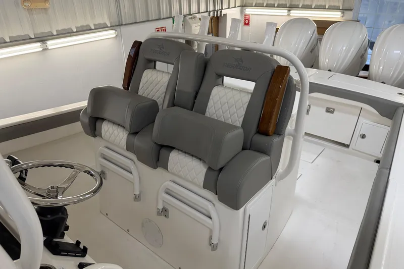 Slide: The Image of 2024 Regulator 34 boat interior with luxurious seating and steering wheel. - 31
