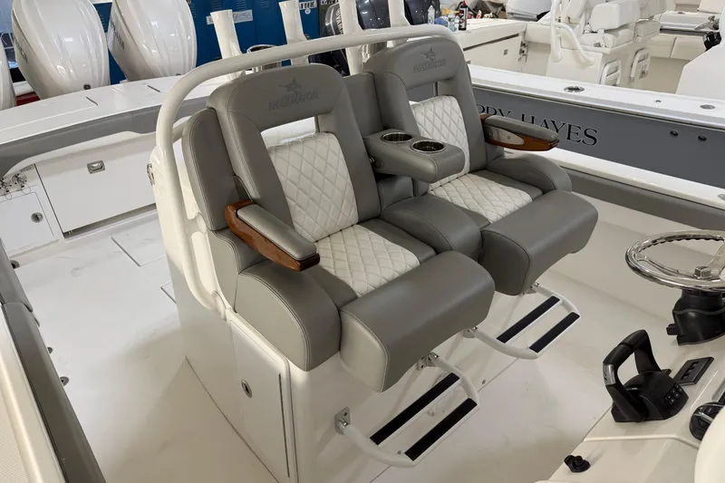 Slide: The Image of 2024 Regulator 34 boat interior with luxurious seating and modern helm controls. - 33