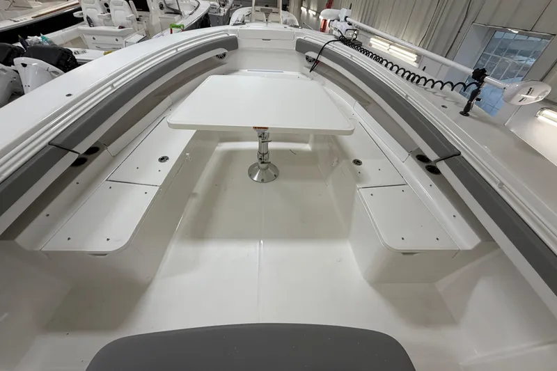 Slide: The Image of 2024 Regulator 34 boat interior with seating and table in a showroom. - 36