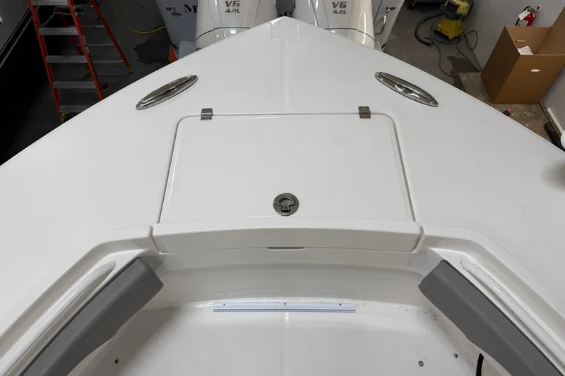 Slide: The Image of 2024 Regulator 34 boat deck with storage compartment and V6 engine in background. - 39