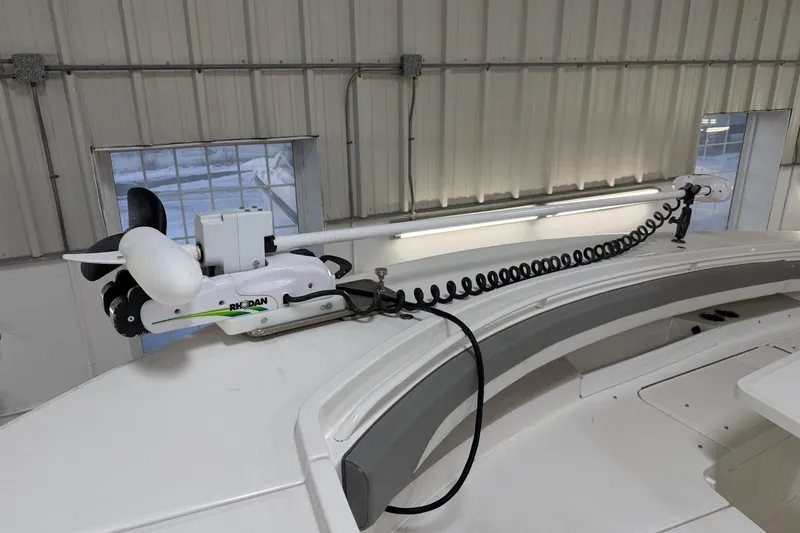 Slide: The Image of 2024 Regulator 34 boat with Rhodan trolling motor in a storage facility. - 41