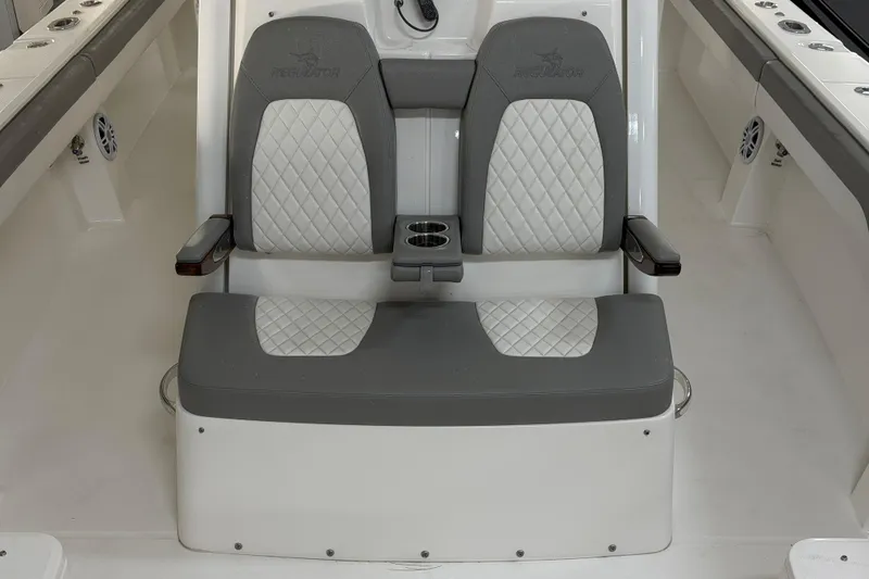 Slide: The Image of 2024 Regulator 34 boat seating with diamond-stitched upholstery and cup holders. - 43