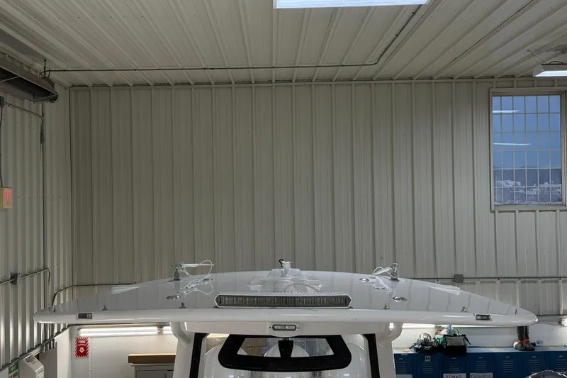 Slide: The Image of 2024 Regulator 34 boat in a metal-walled indoor storage facility. - 44