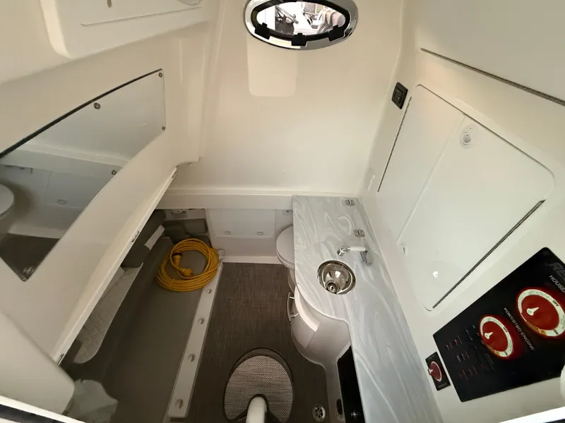 Slide: The Image of 2024 Regulator 34 cabin interior with sink, storage, and control panel. - 9