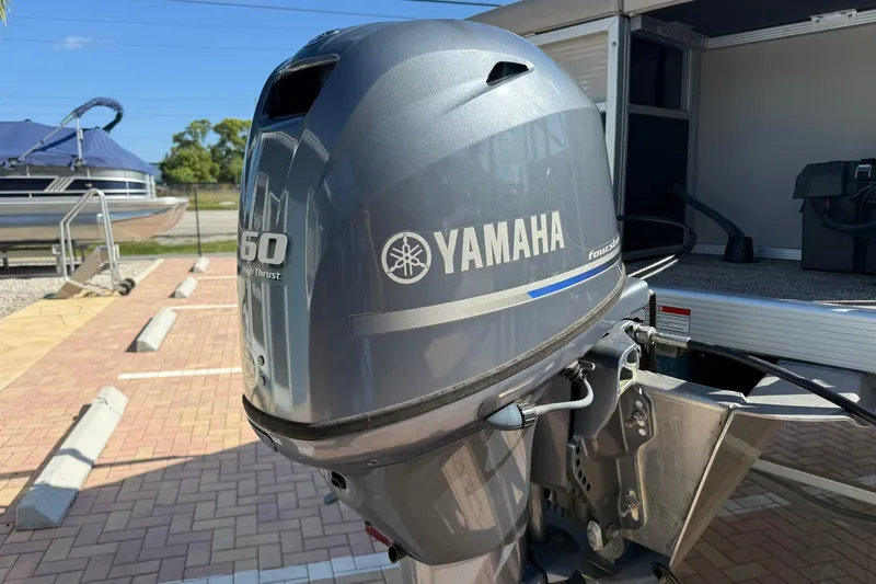 Slide: The Image of Yamaha outboard motor on a 2019 Bennington 188 SLV boat, parked on a sunny day. - 12