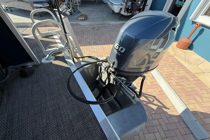 Slide: The Image of 2019 Bennington 188 SLV with Yamaha 60 outboard motor, docked on a sunny day. - 13