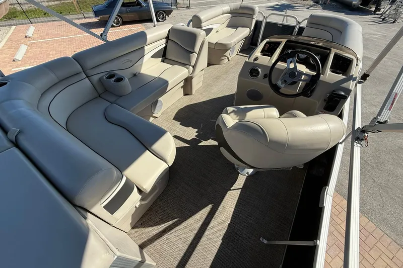 Slide: The Image of 2019 Bennington 188 SLV pontoon boat interior with beige seating and steering console. - 15