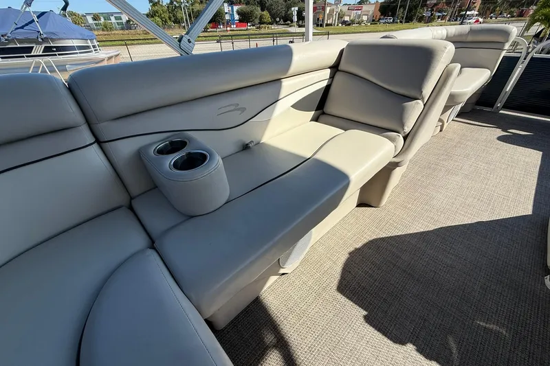 Slide: The Image of 2019 Bennington 188 SLV boat interior with beige seating and cup holders. - 17