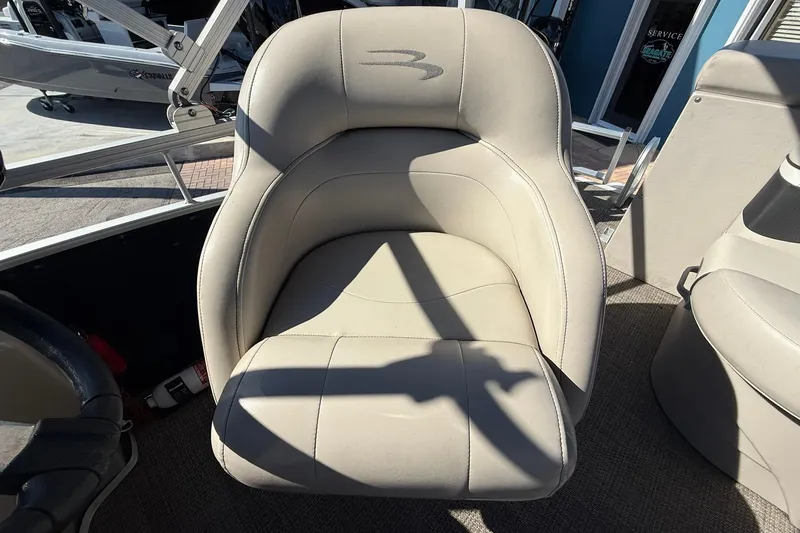 Slide: The Image of 2019 Bennington 188 SLV boat seat with beige upholstery and logo. - 19