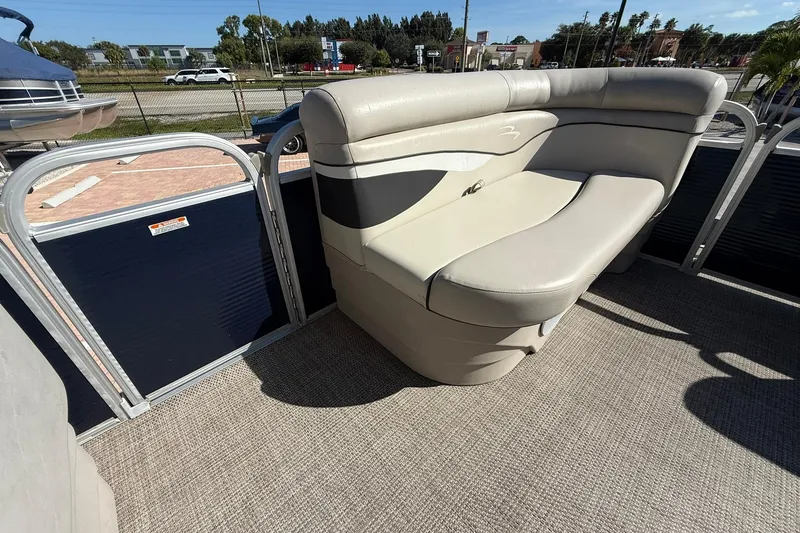 Slide: The Image of 2019 Bennington 188 SLV pontoon boat with beige seating and carpeted deck. - 24