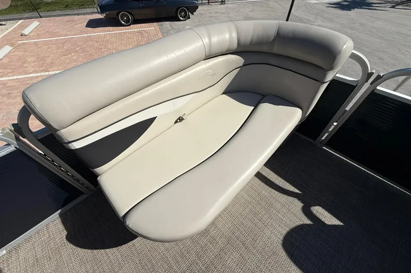 Slide: The Image of 2019 Bennington 188 SLV boat with beige seating and carpeted deck. - 25