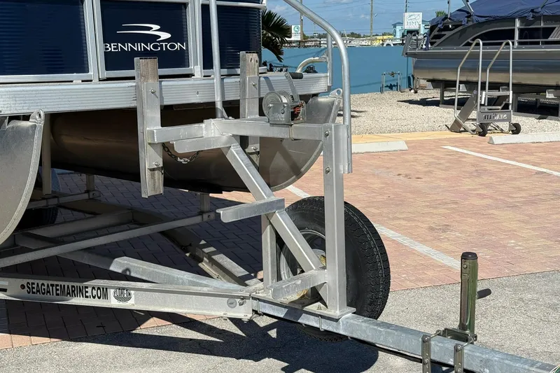 Slide: The Image of 2019 Bennington 188 SLV pontoon boat on trailer in sunny marina. - 29