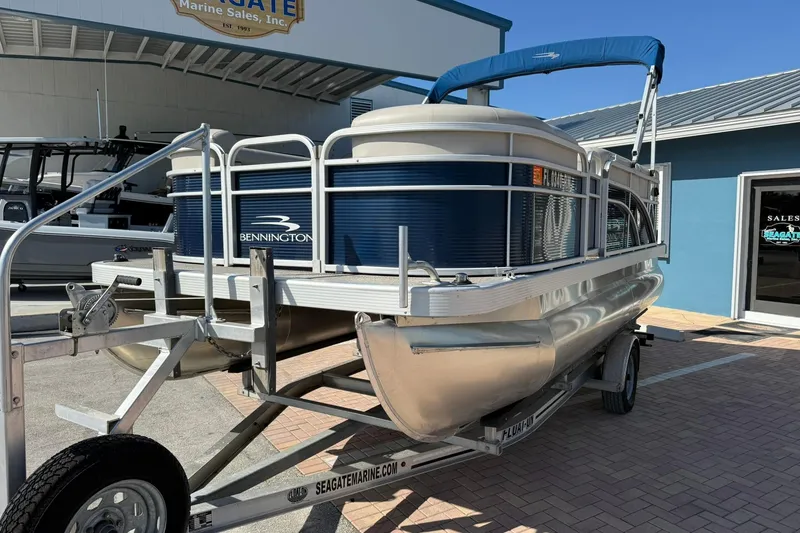 Slide: The Image of 2019 Bennington 188 SLV pontoon boat on trailer at dealership. - 3