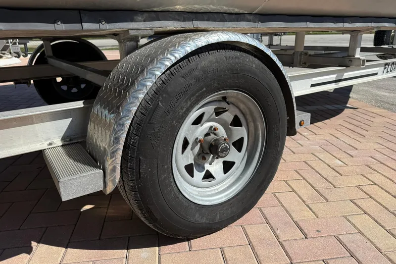 Slide: The Image of Trailer wheel of a 2019 Bennington 188 SLV on a brick pavement. - 30