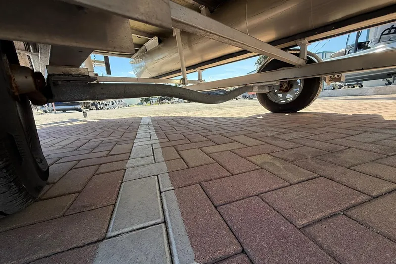 Slide: The Image of Underneath view of a 2019 Bennington 188 SLV trailer on brick pavement. - 32